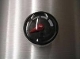 A black and red clock on the side of a wall.