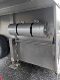 A stainless steel wall with two large rolls of paper.
