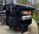 A black trailer with a gas tank on the back.