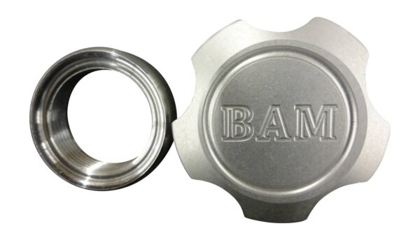 A silver cap and ring with the word bam on it.