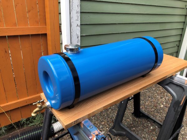 A blue tank sitting on top of a wooden table.