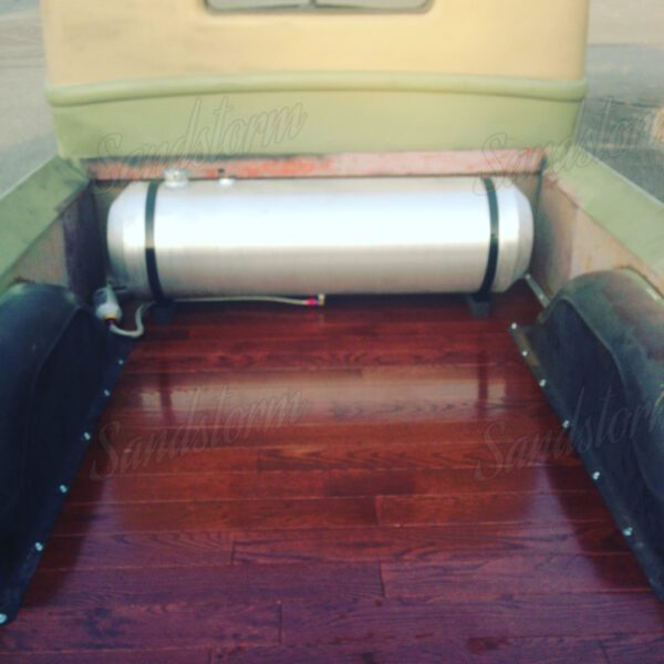 A large metal tank sitting on top of a wooden floor.