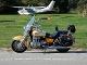 A yellow motorcycle parked on the side of a road.