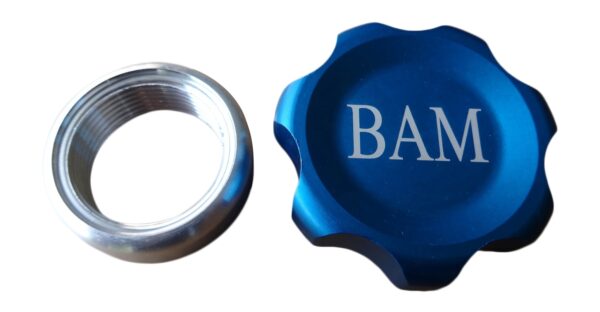 A blue cap and a silver ring with the word bam on it.