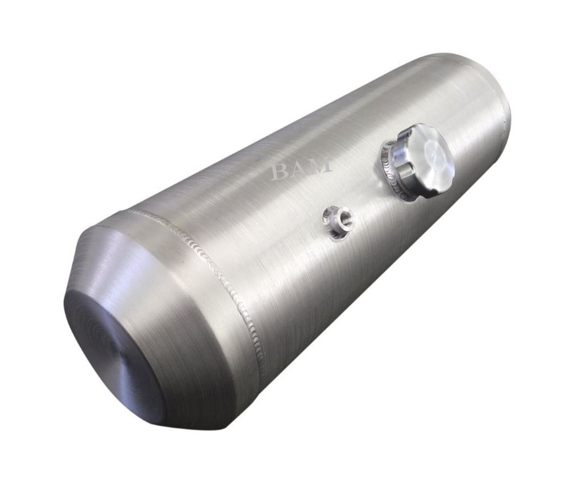 A silver cylinder shaped device with a white object on top of it.