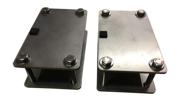 A pair of metal stands with two different types of mounting plates.