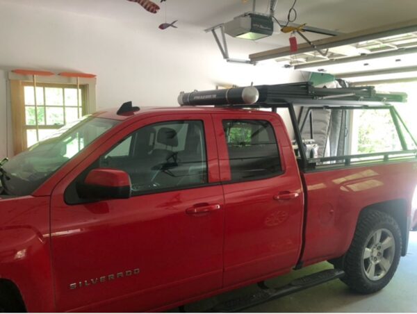 A red truck is parked in the garage.