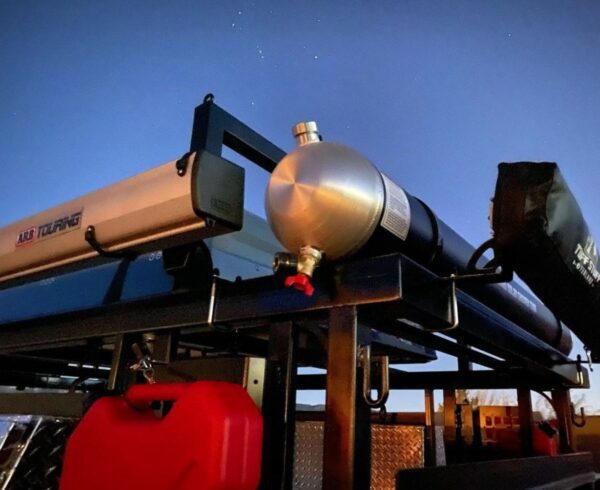 A gas tank mounted to the side of a truck.