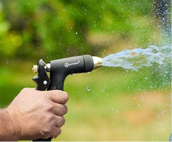 A person spraying water from an air gun.