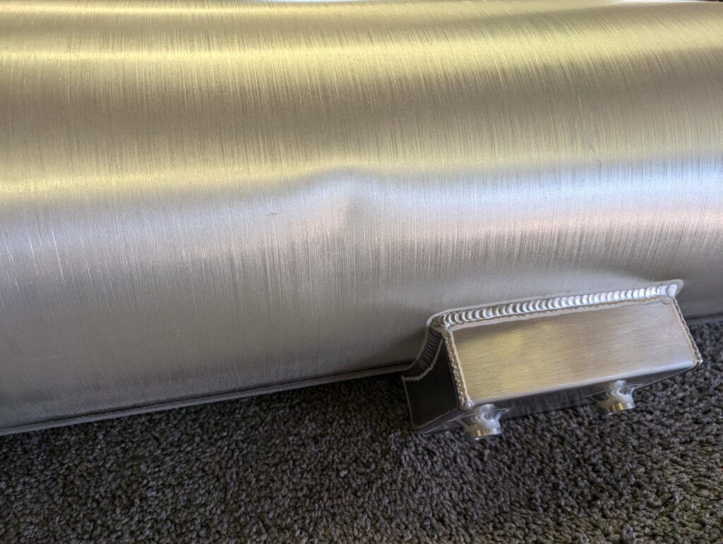 A metal pipe sitting on top of the ground.